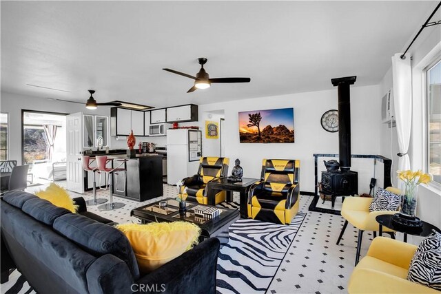 49490 Big Morongo Canyon Rd, Morongo Valley, CA 92256 - living area with ceiling fan, a wood stove, and light flooring