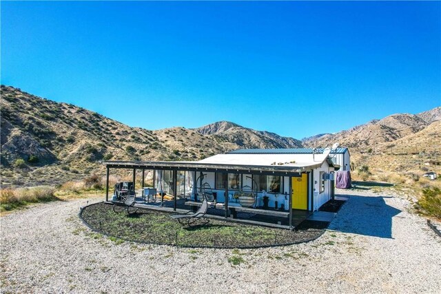 49490 Big Morongo Canyon Rd, Morongo Valley, CA 92256 - rear view of property with a mountain view and a patio
