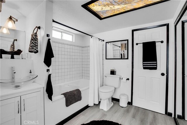 49490 Big Morongo Canyon Rd, Morongo Valley, CA 92256 - bathroom featuring wood finished floors, shower / bath combination with curtain, vanity, and toilet