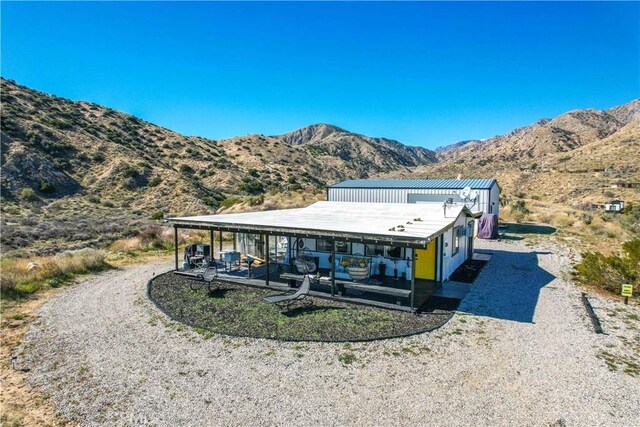 49490 Big Morongo Canyon Rd, Morongo Valley, CA 92256 - back of house with a mountain view, a patio, and driveway