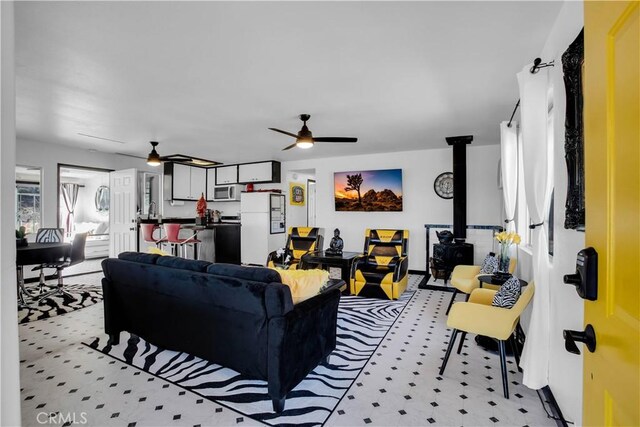 49490 Big Morongo Canyon Rd, Morongo Valley, CA 92256 - living area with a ceiling fan, a wood stove, and light flooring