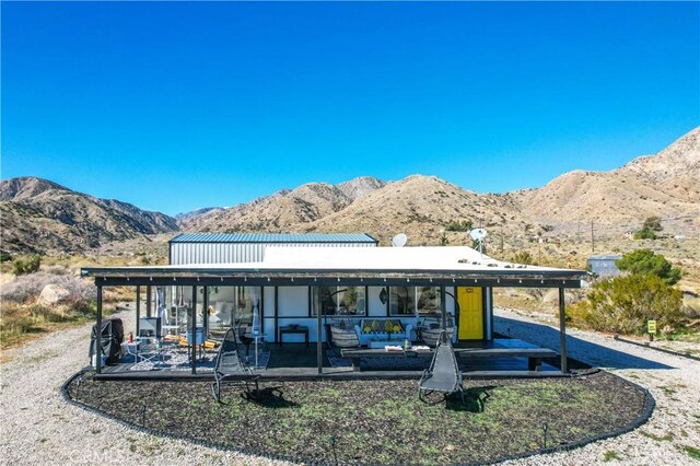 49490 Big Morongo Canyon Rd, Morongo Valley, CA 92256 - rear view of property featuring a mountain view, a patio area, and an outdoor living space