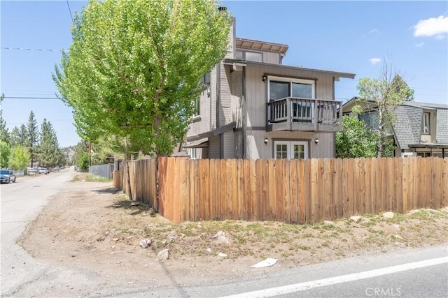 2100 1st Ln, Big Bear City, CA 92314 - view of front facade featuring a balcony and a chimney