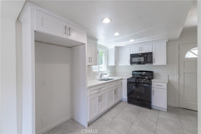 2100 1st Ln, Big Bear City, CA 92314 - kitchen with black appliances, white cabinets, light countertops, recessed lighting, and light tile patterned flooring