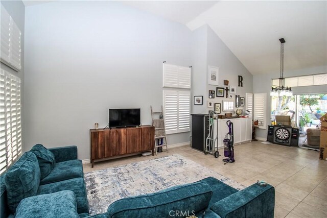 7223 Yarnell Rd, Highland, CA 92346 - living room with high vaulted ceiling, tile patterned flooring, and baseboards