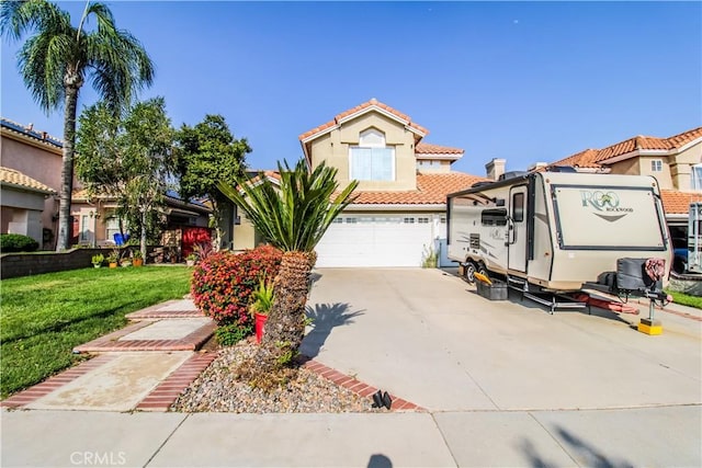 7223 Yarnell Rd, Highland, CA 92346 - mediterranean / spanish-style home featuring a front yard, a tile roof, driveway, a garage, and stucco siding