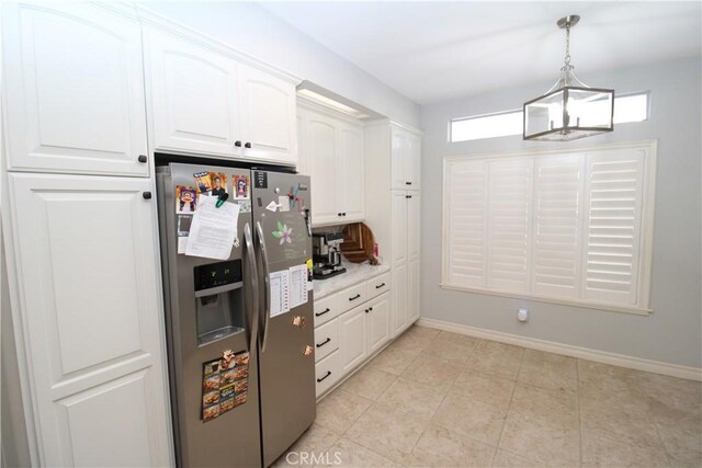 7223 Yarnell Rd, Highland, CA 92346 - kitchen featuring stainless steel fridge, white cabinetry, decorative light fixtures, and baseboards