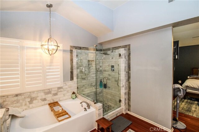 7223 Yarnell Rd, Highland, CA 92346 - ensuite bathroom with a bath, a stall shower, wood finished floors, vaulted ceiling, and a chandelier