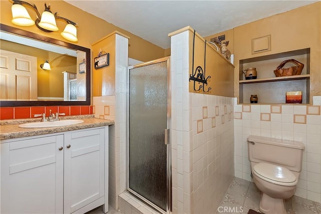 1192 Evergreen Ln, Lake Arrowhead, CA 92352 - full bathroom with tile walls, a shower stall, vanity, tile patterned flooring, and toilet