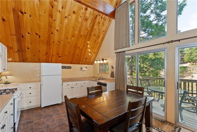 1192 Evergreen Ln, Lake Arrowhead, CA 92352 - dining area with healthy amount of natural light, high vaulted ceiling, and stone finish flooring
