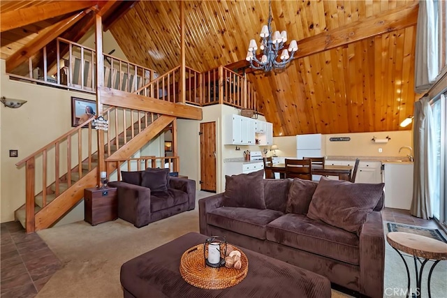 1192 Evergreen Ln, Lake Arrowhead, CA 92352 - carpeted living room featuring a chandelier, stairs, wooden ceiling with exposed beams, and high vaulted ceiling