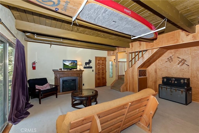 1192 Evergreen Ln, Lake Arrowhead, CA 92352 - living room featuring carpet, stairway, a glass covered fireplace, and wooden ceiling with exposed beams