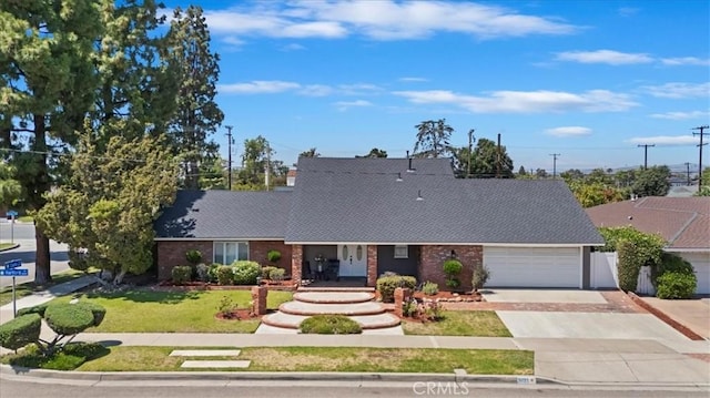 3021 E Hartford Rd, Orange, CA 92869 - view of front of house with driveway, an attached garage, a front lawn, and brick siding