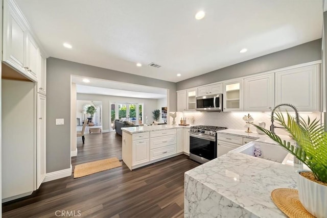 3021 E Hartford Rd, Orange, CA 92869 - kitchen featuring stainless steel appliances, a peninsula, backsplash, dark wood-style floors, and recessed lighting