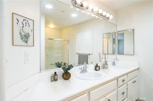 1065 Vaquero Cir, Oxnard, CA 93030 - bathroom featuring double vanity, a shower with door, and recessed lighting