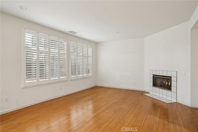 1065 Vaquero Cir, Oxnard, CA 93030 - unfurnished living room featuring light wood-type flooring, a tile fireplace, and baseboards