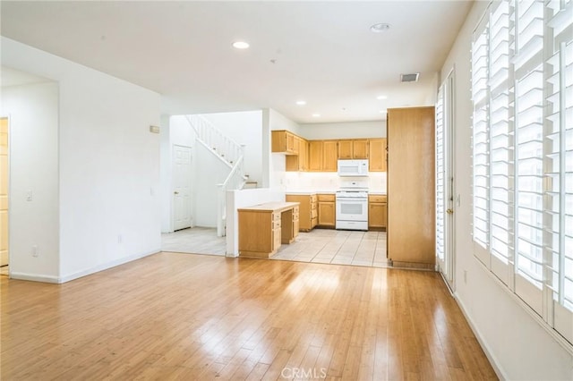 1065 Vaquero Cir, Oxnard, CA 93030 - kitchen featuring white appliances, light wood-style floors, healthy amount of natural light, light countertops, and recessed lighting