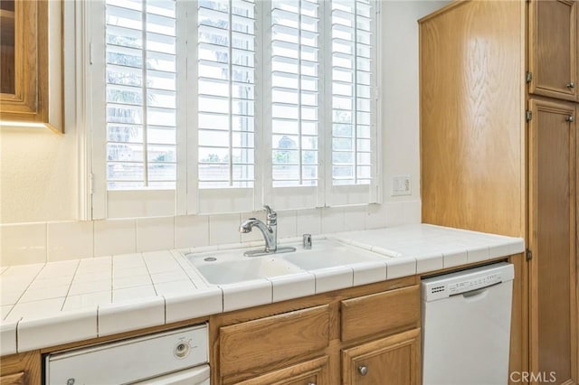 1065 Vaquero Cir, Oxnard, CA 93030 - kitchen with dishwasher, a sink, brown cabinets, and decorative backsplash