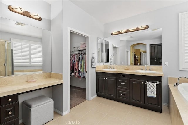 25079 Loring Rd, Wildomar, CA 92595 - bathroom featuring double vanity, a spacious closet, a stall shower, tile patterned flooring, and a garden tub