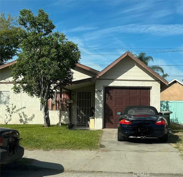 1757 Riverside Ave, Colton, CA 92324 - view of front of home with an attached garage, a front lawn, stucco siding, and driveway