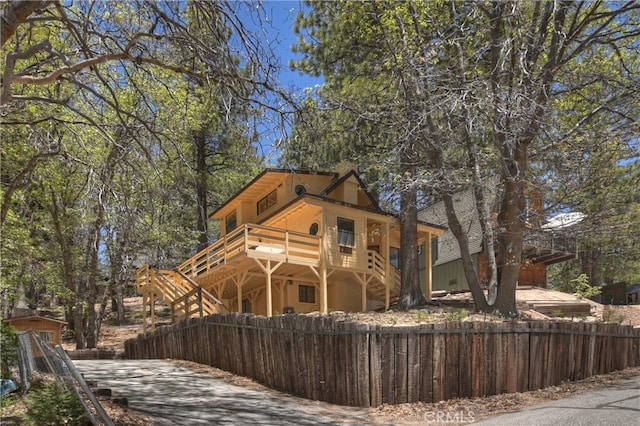 33294 Wild Rose Dr, Green Valley Lake, CA 92341 - rustic home with a fenced front yard and a balcony