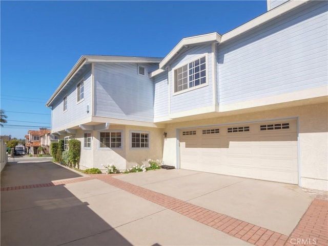 2018 Bataan Rd Unit A, Redondo Beach, CA 90278 - view of front of home featuring driveway, stucco siding, and a garage