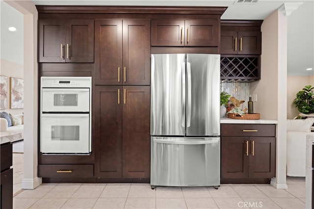 20 Chenile, Irvine, CA 92614 - kitchen featuring freestanding refrigerator, double oven, dark brown cabinets, and light countertops