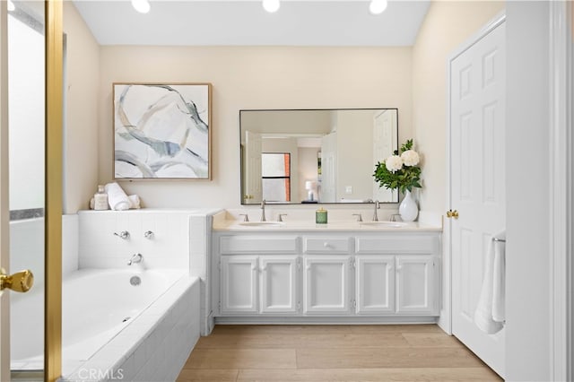 20 Chenile, Irvine, CA 92614 - bathroom with double vanity, a bath, wood finished floors, and recessed lighting