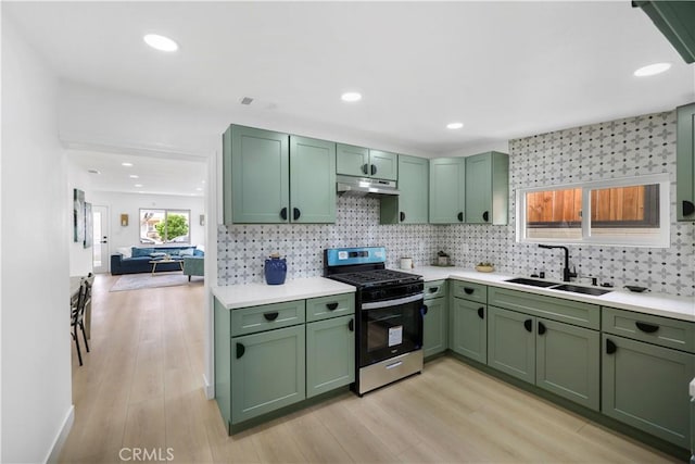 2218 S Meridian Ave, Alhambra, CA 91803 - kitchen featuring green cabinetry, stainless steel range with gas stovetop, a sink, under cabinet range hood, and light countertops