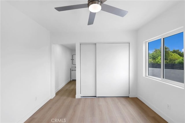 2218 S Meridian Ave, Alhambra, CA 91803 - unfurnished bedroom featuring light wood-style flooring, a closet, baseboards, and a ceiling fan