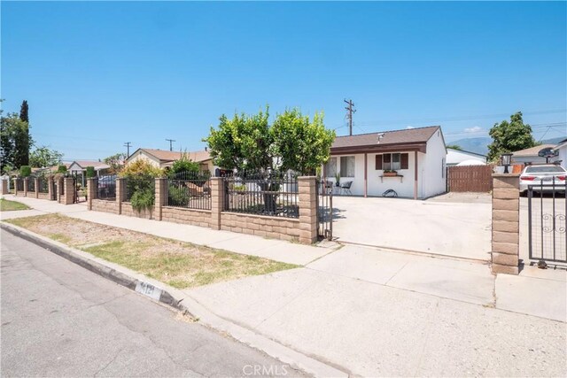 14121 Calais St, Baldwin Park, CA 91706 - view of front of property featuring concrete driveway, a fenced front yard, a gate, and stucco siding