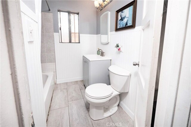 14121 Calais St, Baldwin Park, CA 91706 - full bath featuring toilet, vanity, a wainscoted wall, and shower / tub combination