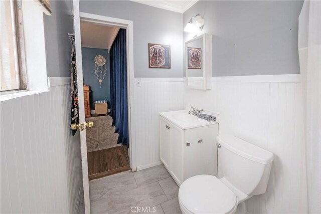 14121 Calais St, Baldwin Park, CA 91706 - bathroom with wainscoting, vanity, toilet, marble finish floors, and crown molding