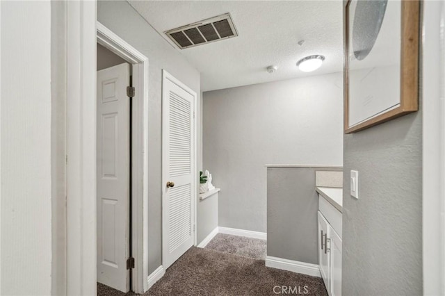8167 Vineyard Ave Unit 109, Rancho Cucamonga, CA 91730 - corridor featuring dark colored carpet and baseboards