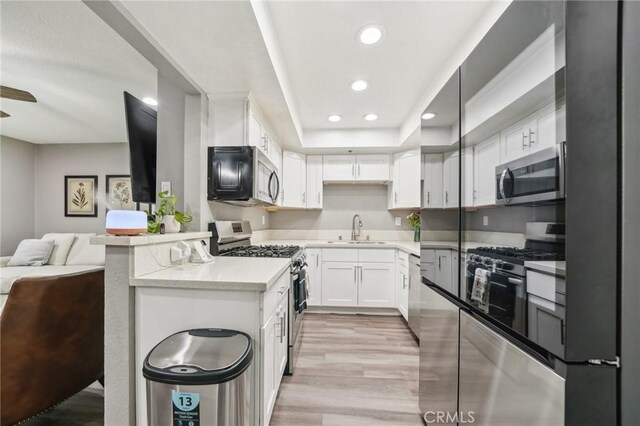 8167 Vineyard Ave Unit 109, Rancho Cucamonga, CA 91730 - kitchen with stainless steel appliances, a sink, open floor plan, recessed lighting, and light countertops