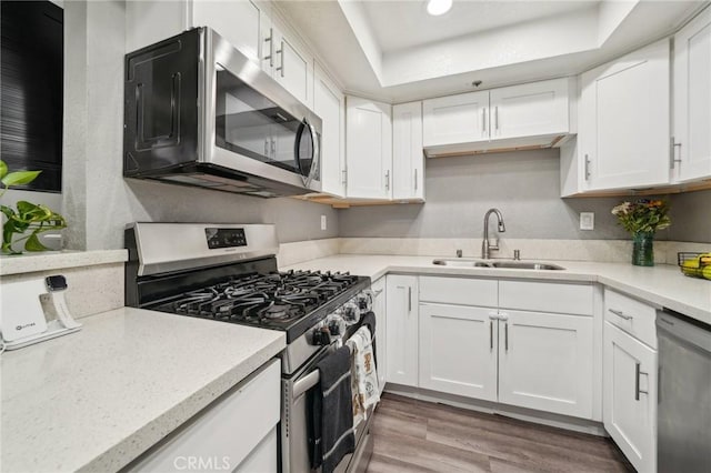8167 Vineyard Ave Unit 109, Rancho Cucamonga, CA 91730 - kitchen with appliances with stainless steel finishes, a sink, white cabinetry, and light countertops