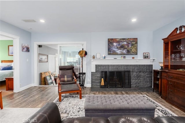 1501 W Baker Ave, Fullerton, CA 92833 - living room with wood finished floors, a brick fireplace, recessed lighting, and baseboards