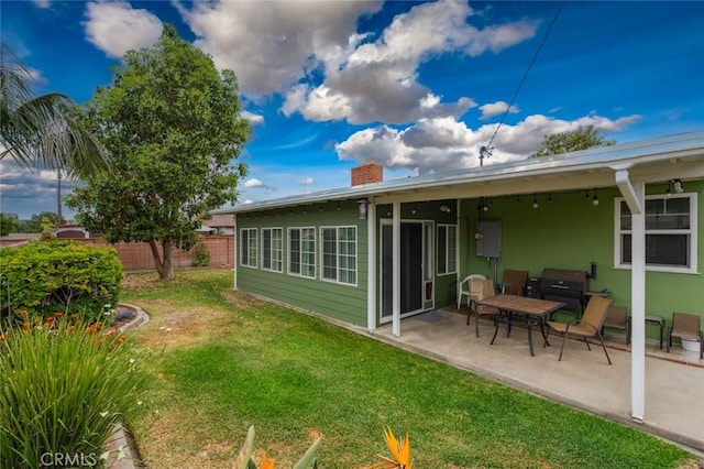 1501 W Baker Ave, Fullerton, CA 92833 - rear view of house with a patio area, a chimney, and stucco siding