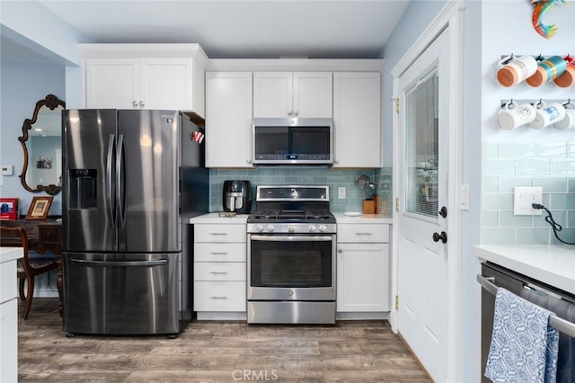 1501 W Baker Ave, Fullerton, CA 92833 - kitchen with appliances with stainless steel finishes, tasteful backsplash, light countertops, and white cabinets