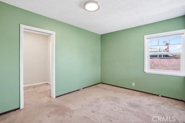 1501 W Baker Ave, Fullerton, CA 92833 - unfurnished bedroom featuring a textured ceiling and carpet floors