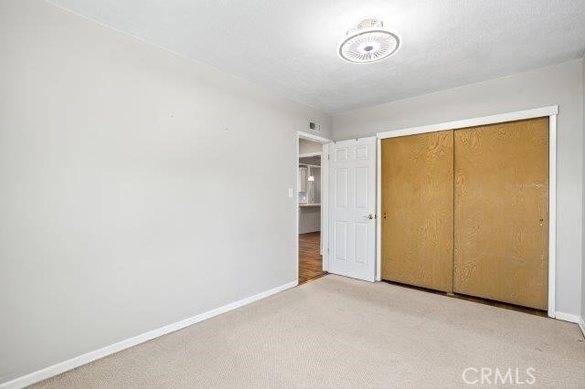 1501 W Baker Ave, Fullerton, CA 92833 - unfurnished bedroom with light colored carpet and a closet