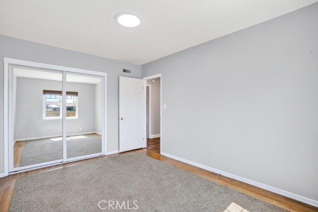 1501 W Baker Ave, Fullerton, CA 92833 - unfurnished bedroom featuring wood finished floors and a closet