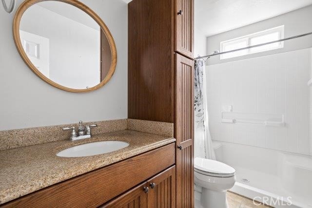 1501 W Baker Ave, Fullerton, CA 92833 - bathroom featuring a shower with curtain and vanity