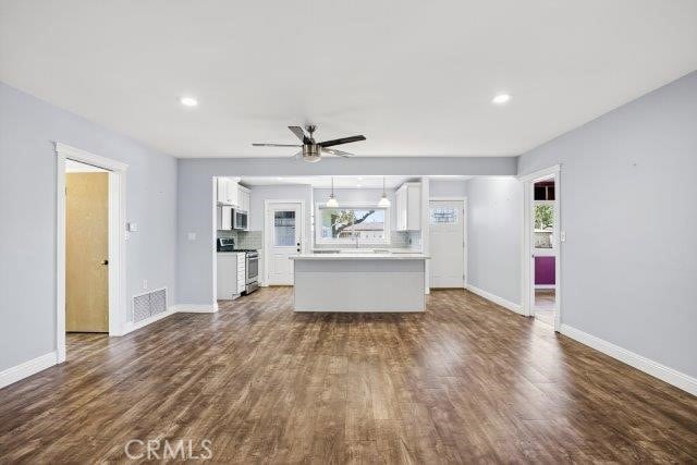 1501 W Baker Ave, Fullerton, CA 92833 - unfurnished living room with dark wood-type flooring, a ceiling fan, and recessed lighting