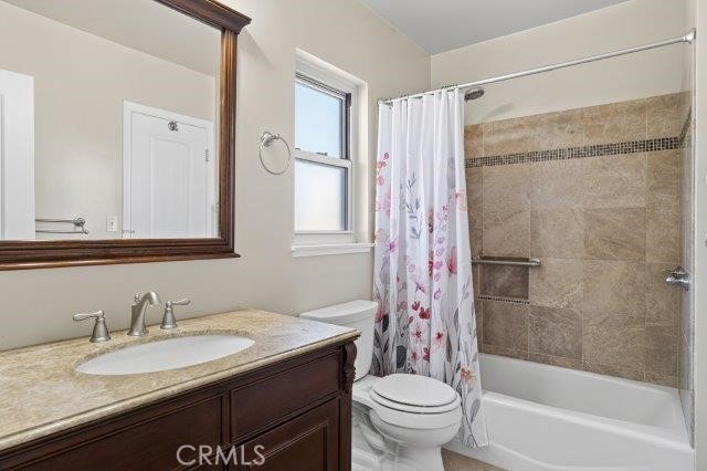 1501 W Baker Ave, Fullerton, CA 92833 - bathroom featuring vanity and shower / bathtub combination with curtain