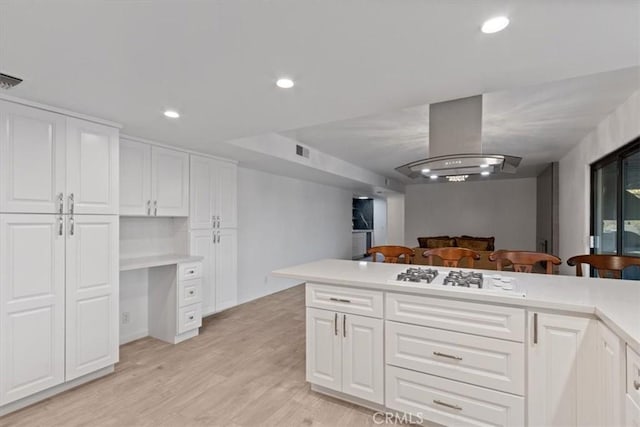 42722 20th St W, Lancaster, CA 93534 - kitchen featuring white gas stovetop, white cabinets, light countertops, light wood-type flooring, and recessed lighting