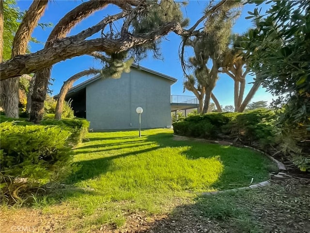 42722 20th St W, Lancaster, CA 93534 - view of side of home featuring stucco siding and a yard