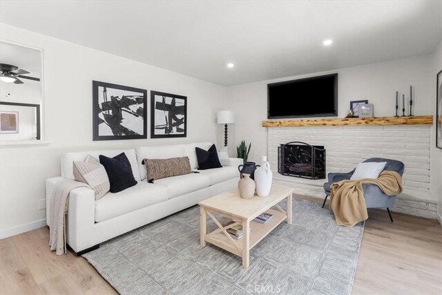 246 Aldama Ave, Pomona, CA 91767 - living area featuring wood finished floors, a fireplace, recessed lighting, and ceiling fan