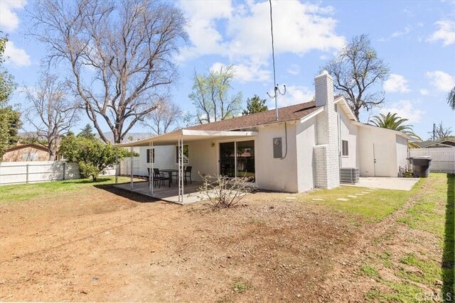 246 Aldama Ave, Pomona, CA 91767 - back of house with a patio, a fenced backyard, a chimney, and stucco siding