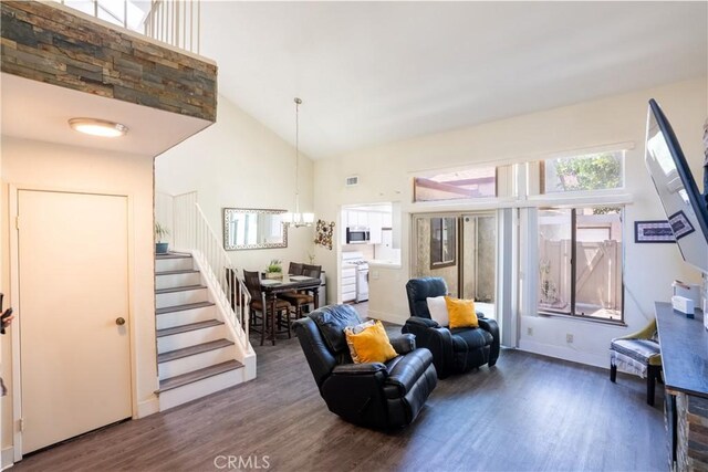 1643 Golden Tree Ct Unit C, Corona, CA 92879 - living room with wood finished floors, stairway, high vaulted ceiling, a chandelier, and baseboards